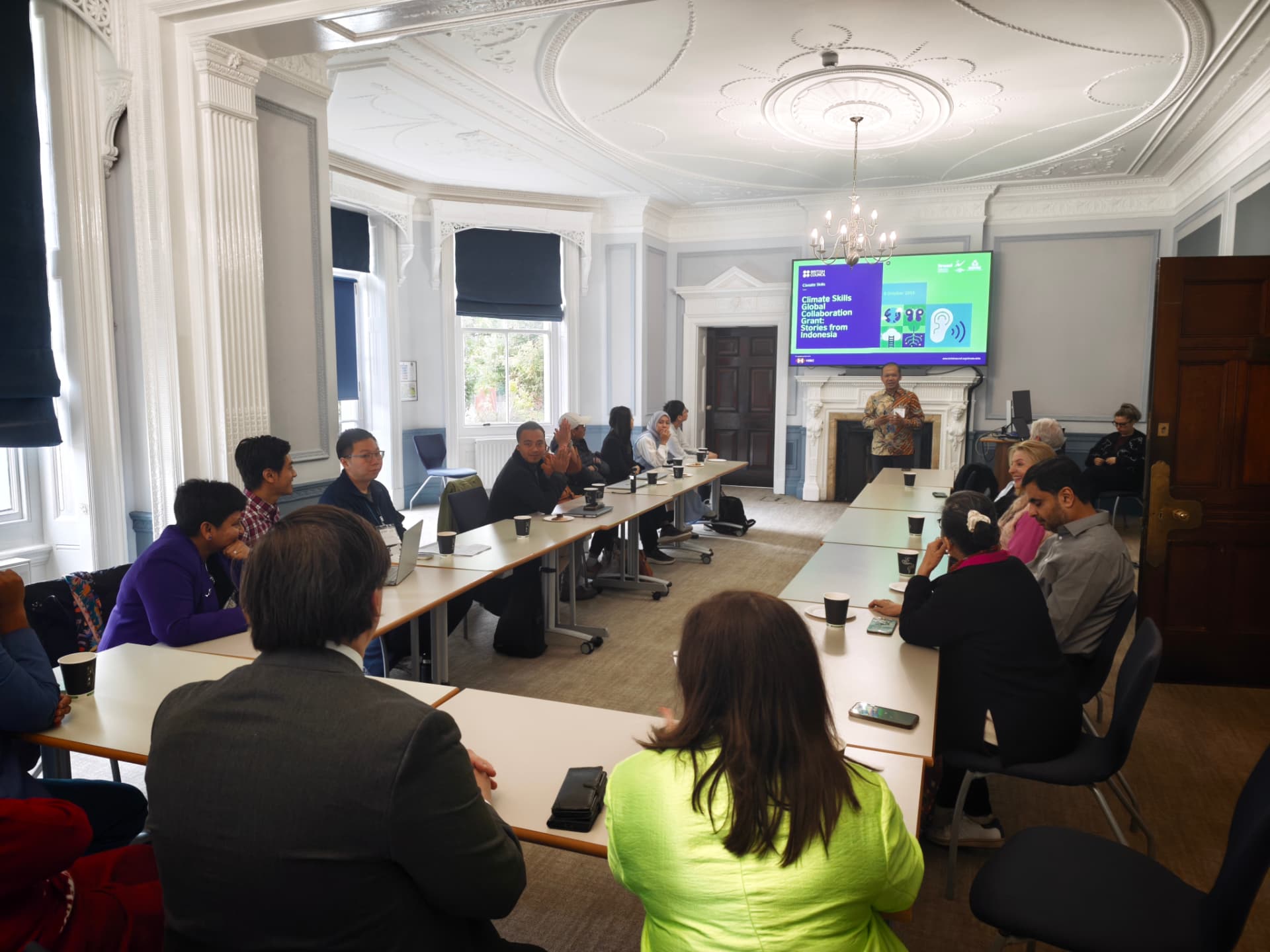A speaker presenting to seated delegates during the Indonesia trade event at Spring Grove House